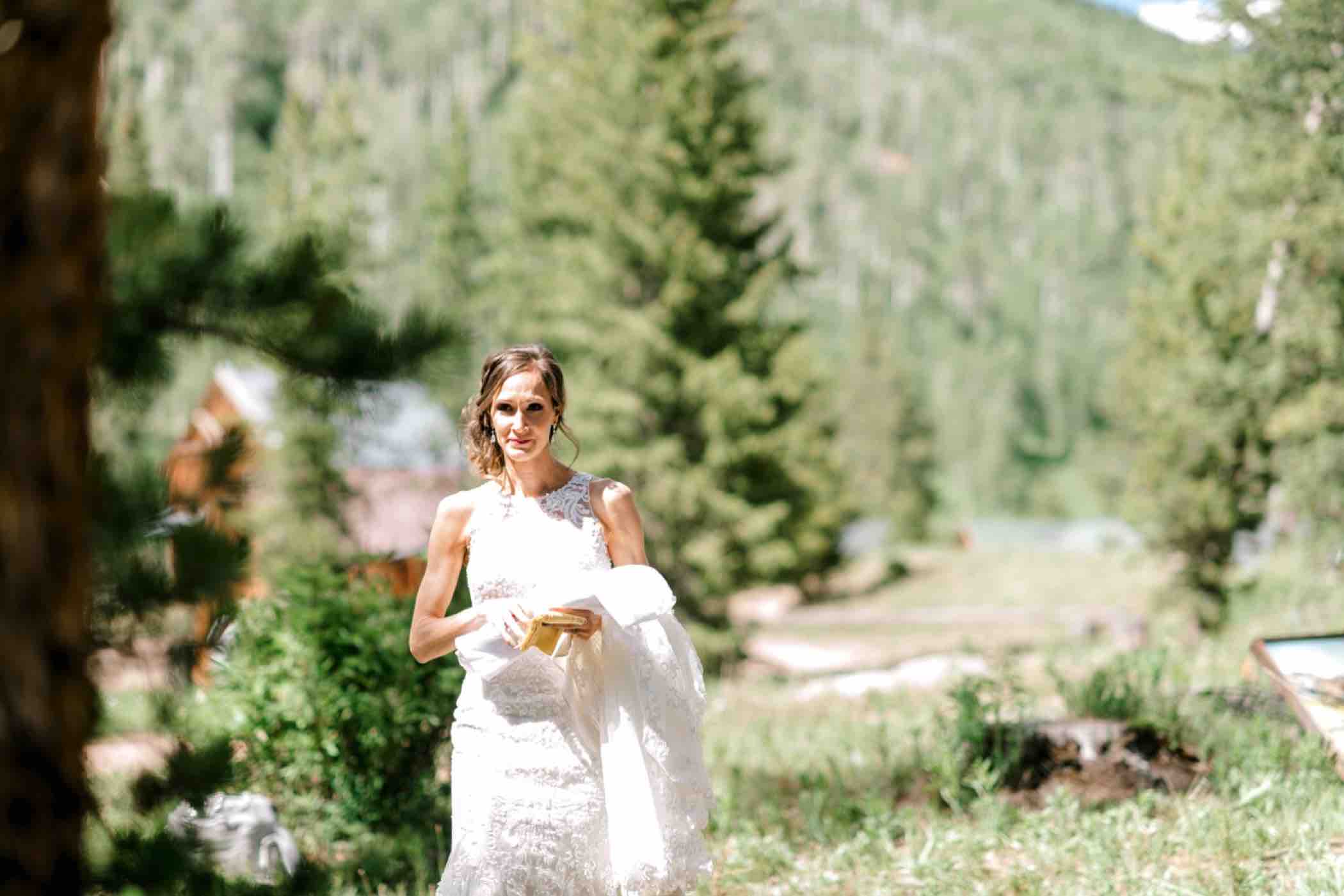 Sallie, the bride, arrives for her first touch ceremony with Kris outside Piney River Ranch in Vail Colorado. Photo by Ali and Garrett, Romantic, Adventurous, Nostalgic Wedding Photographers.