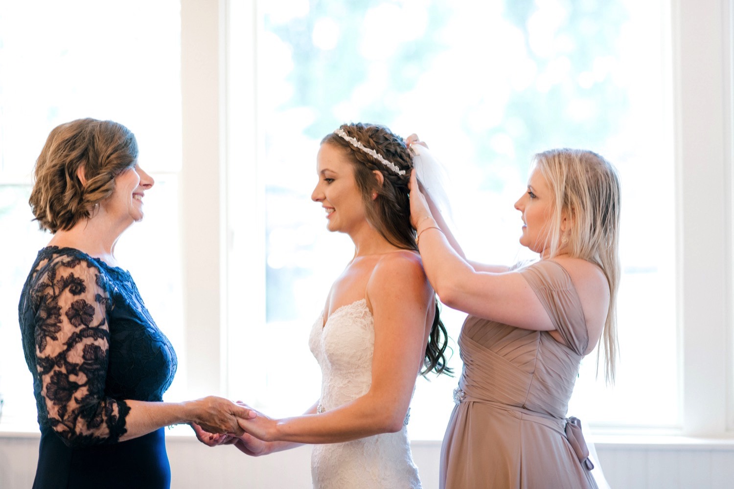 Bride gets ready with her sister and mother's help at Spruce Mountain Ranch in Larkspur Colorado.