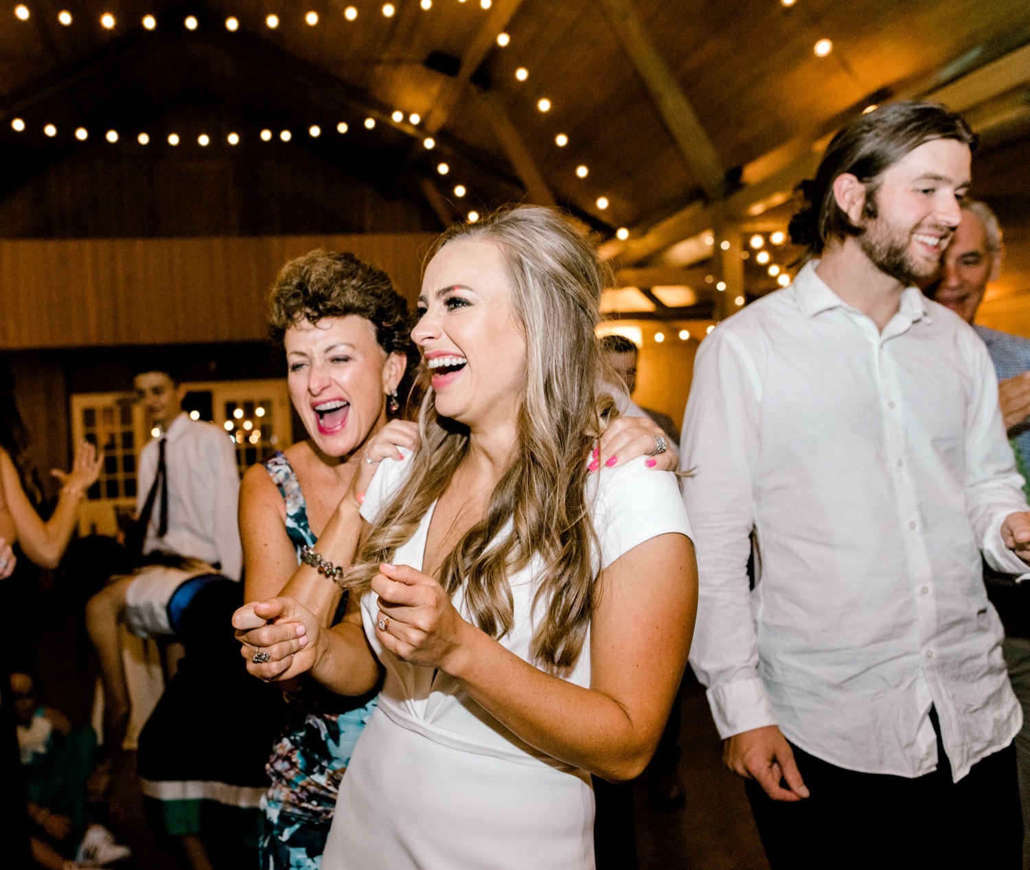 bride and wedding guests laughing together