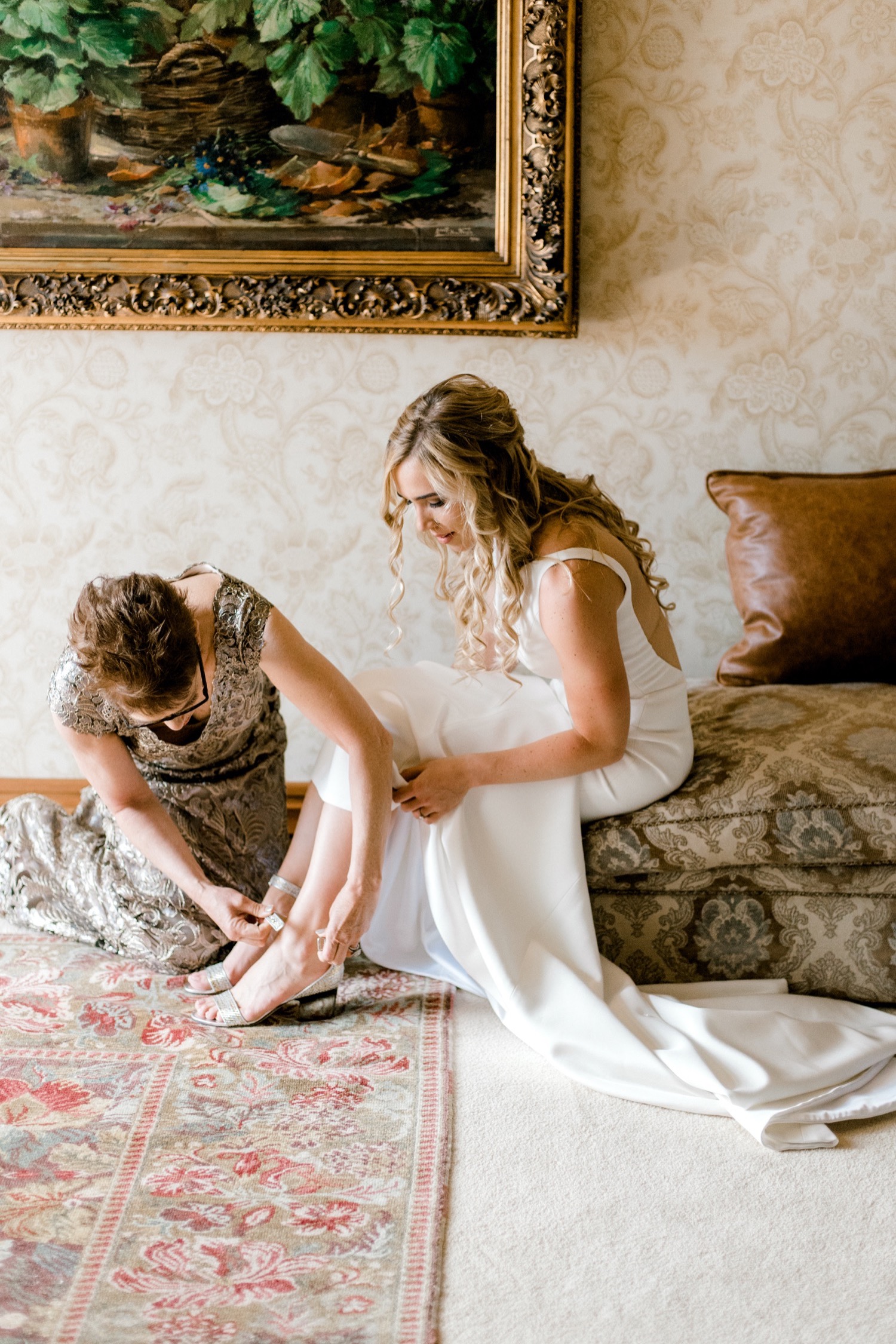 mom puts brides shoes on crested butte wedding