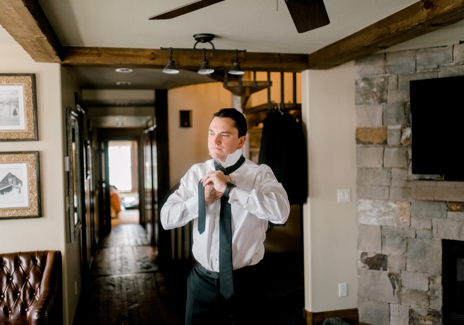 groom putting on tie crested butte wedding