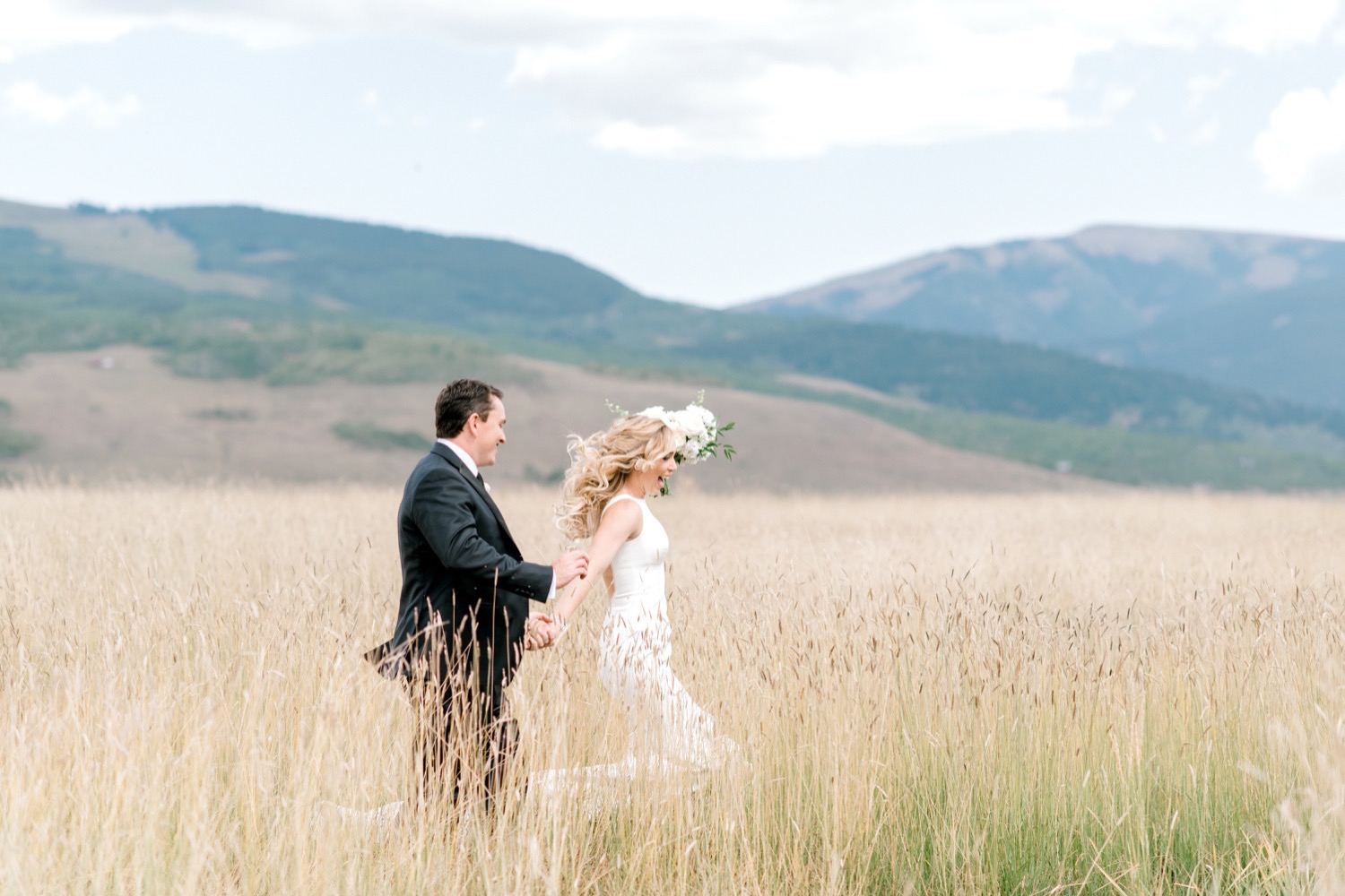 bride and groom in field crested butte wedding