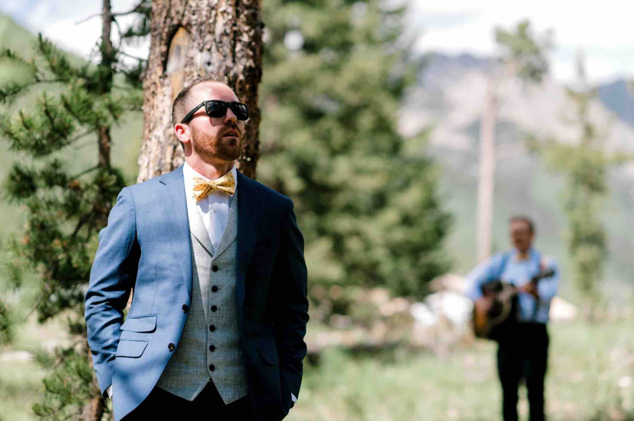 Groom waits for bride before their first touch before their wedding at Piney River Ranch in Vail Colorado. Photo by Ali and Garrett, Romantic, Adventurous, Nostalgic Wedding Photographers.