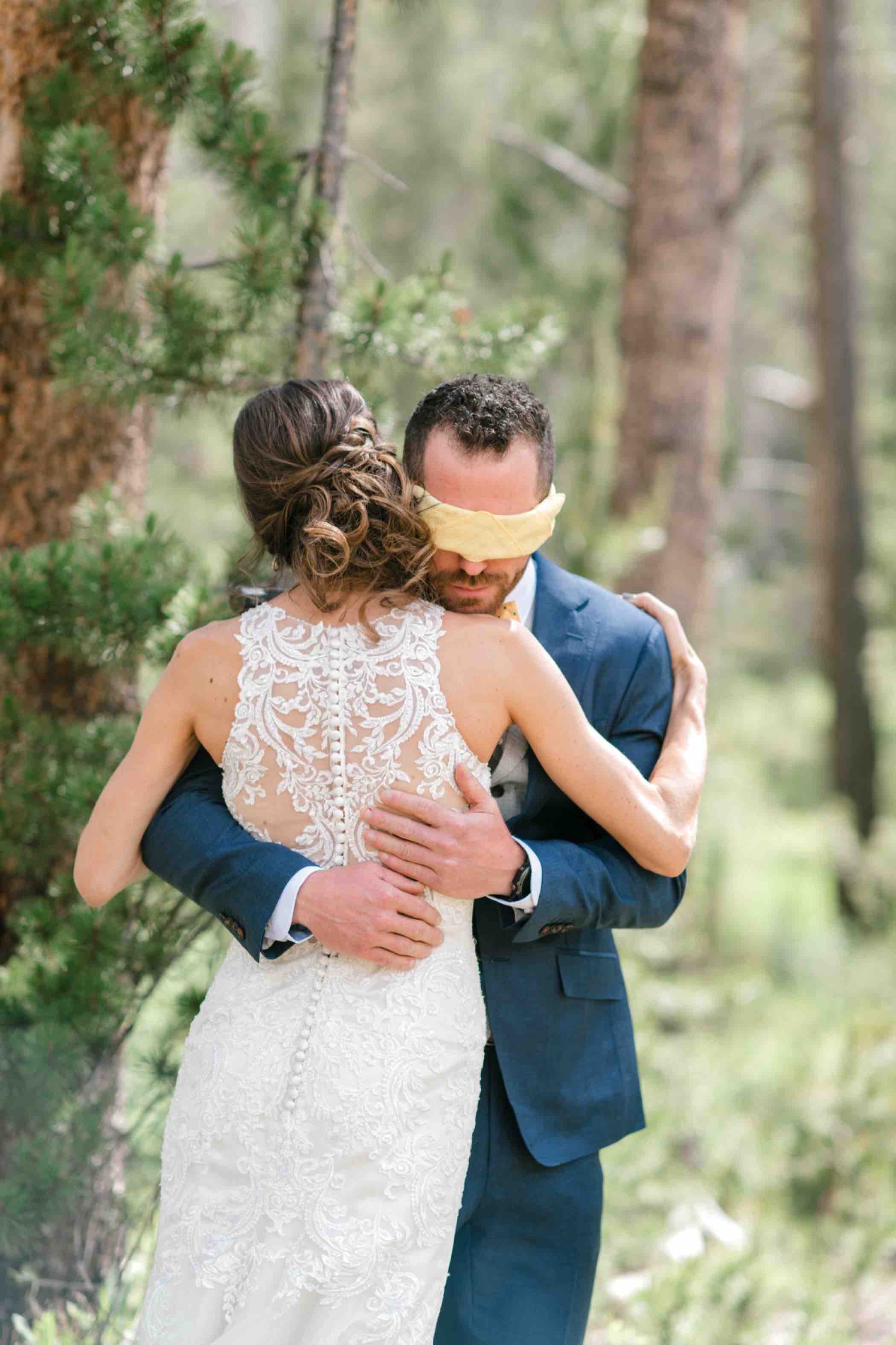 Bride and groom during their first touch ceremony instead of a first look at Piney River Ranch in Vail Colorado. Photo by Ali and Garrett, Romantic, Adventurous, Nostalgic Wedding Photographers.