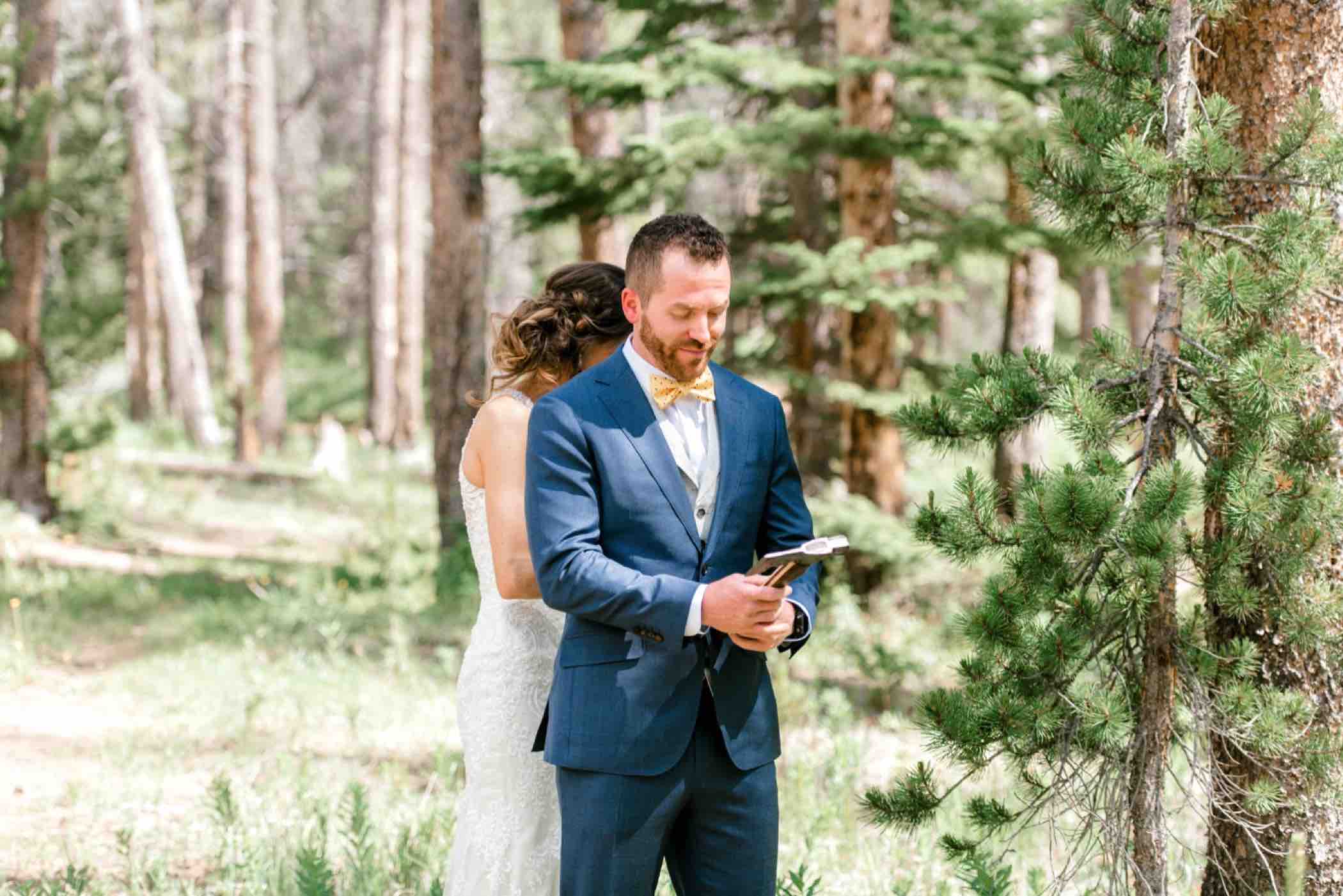 Bride and groom exchange gifts during their first touch ceremony instead of a first look at Piney River Ranch in Vail Colorado. Photo by Ali and Garrett, Romantic, Adventurous, Nostalgic Wedding Photographers.