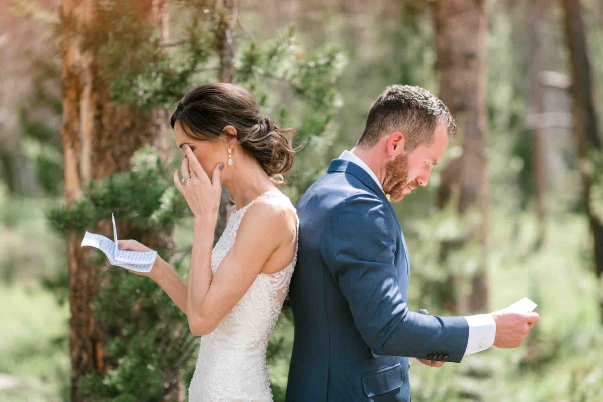 Bride and groom cry while reading letters to each other during their first touch ceremony instead of a first look at Piney River Ranch in Vail Colorado. Photo by Ali and Garrett, Romantic, Adventurous, Nostalgic Wedding Photographers.