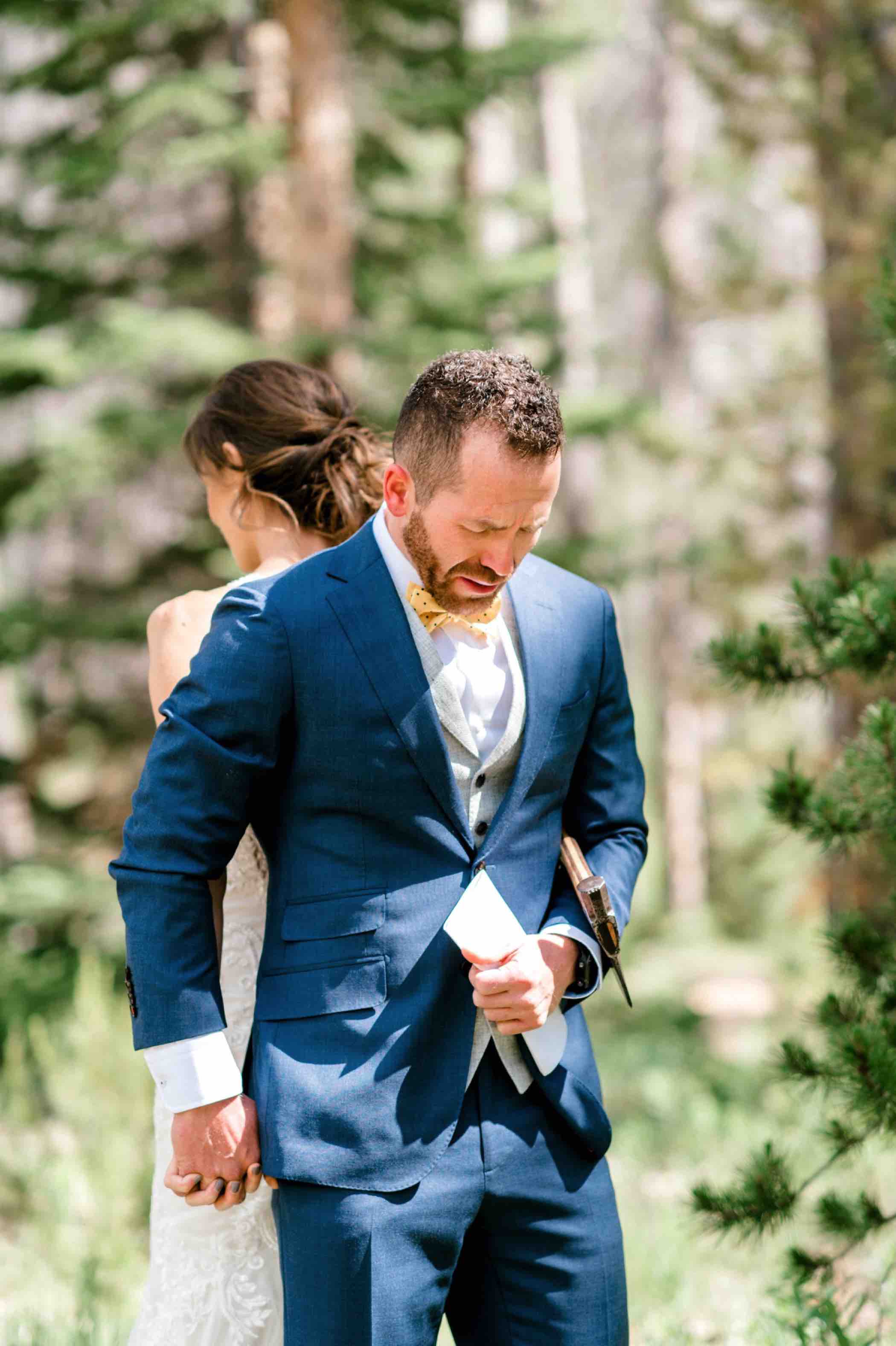Bride and groom pray together during their first touch ceremony instead of a first look at Piney River Ranch in Vail Colorado. Photo by Ali and Garrett, Romantic, Adventurous, Nostalgic Wedding Photographers.
