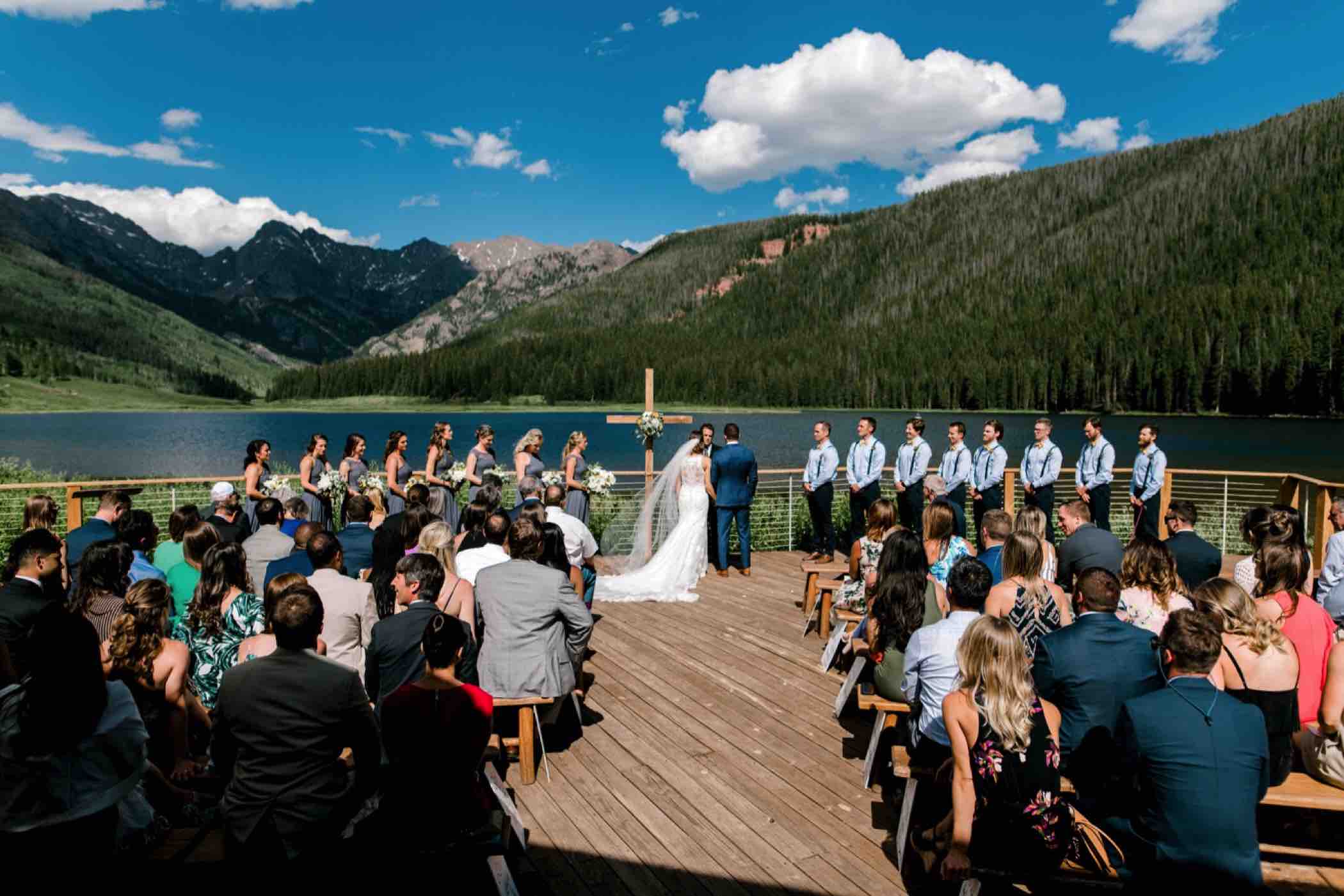 The Gore Range of the Colorado Rocky Mountains are visible from the ceremony site at Piney River Ranch, a wedding venue in Vail. Photo by Ali and Garrett, Romantic, Adventurous, Nostalgic Wedding Photographers.