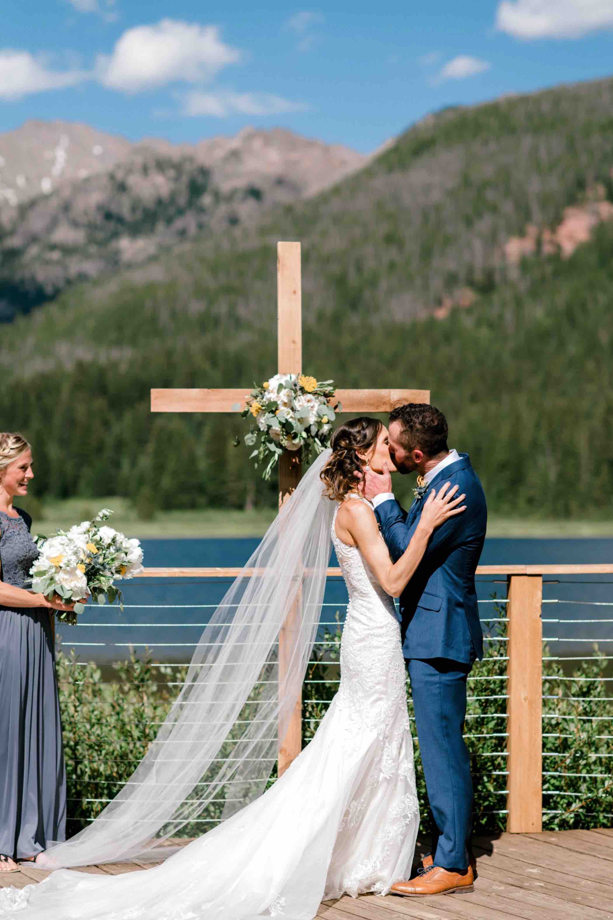 Bride and groom share their first kiss as a married couple at Piney River Ranch in Vail, Colorado. Photo by Ali and Garrett, Romantic, Adventurous, Nostalgic Wedding Photographers.