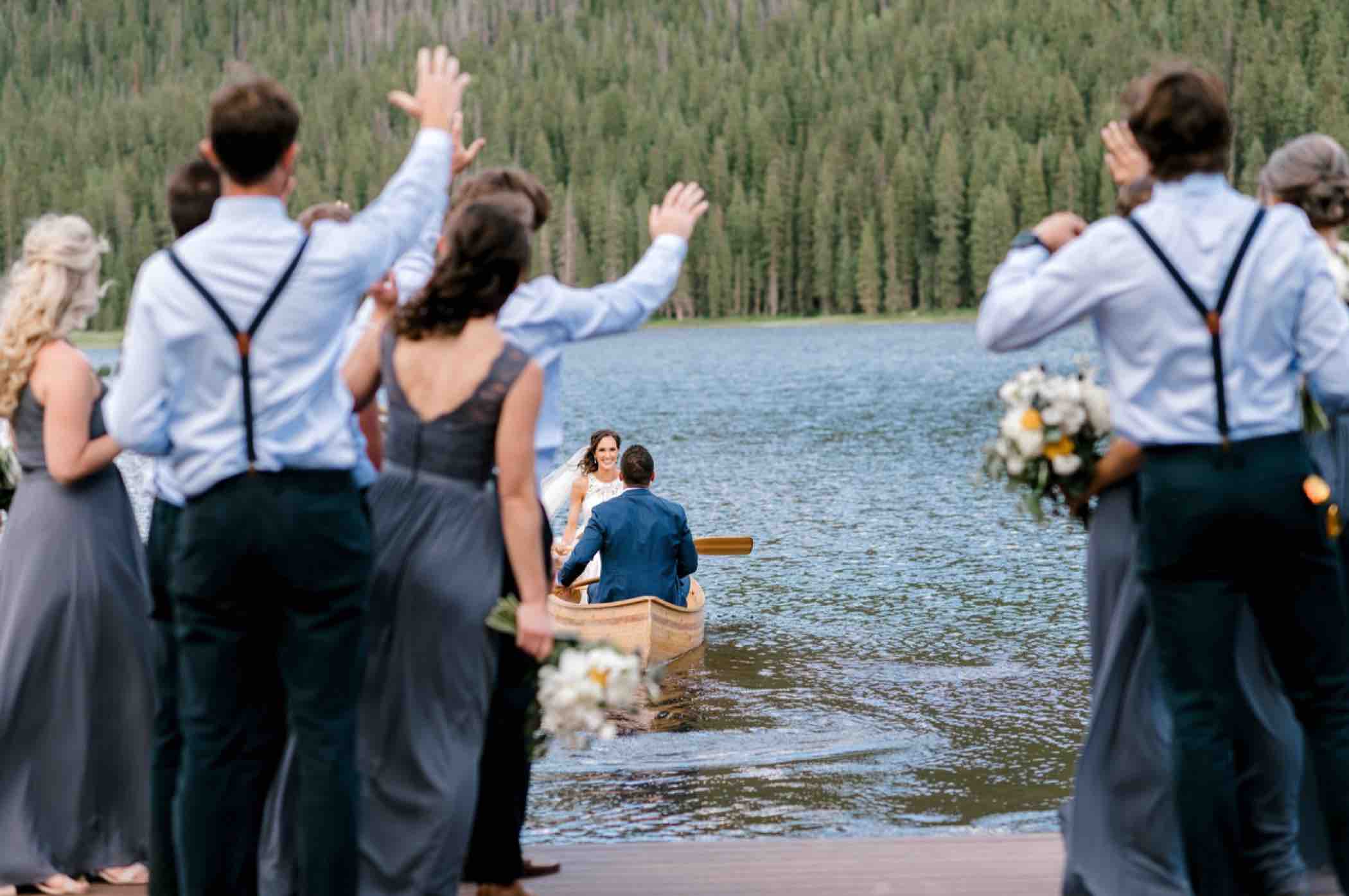 Bride and groom leave in a canoe on Piney Lake in Piney River Ranch in Vail Colorado. Photo by Ali and Garrett, Romantic, Adventurous, Nostalgic Wedding Photographers.