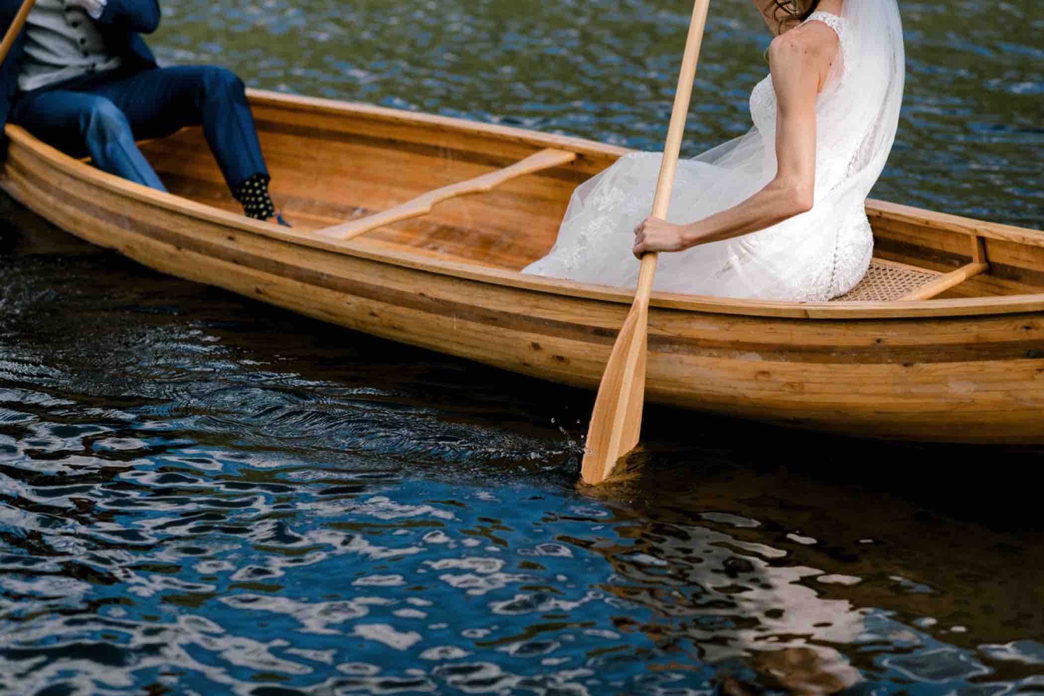 Bride and groom photos in a canoe after their wedding ceremony at Piney River Ranch. Photo by Ali and Garrett, Romantic, Adventurous, Nostalgic Wedding Photographers.