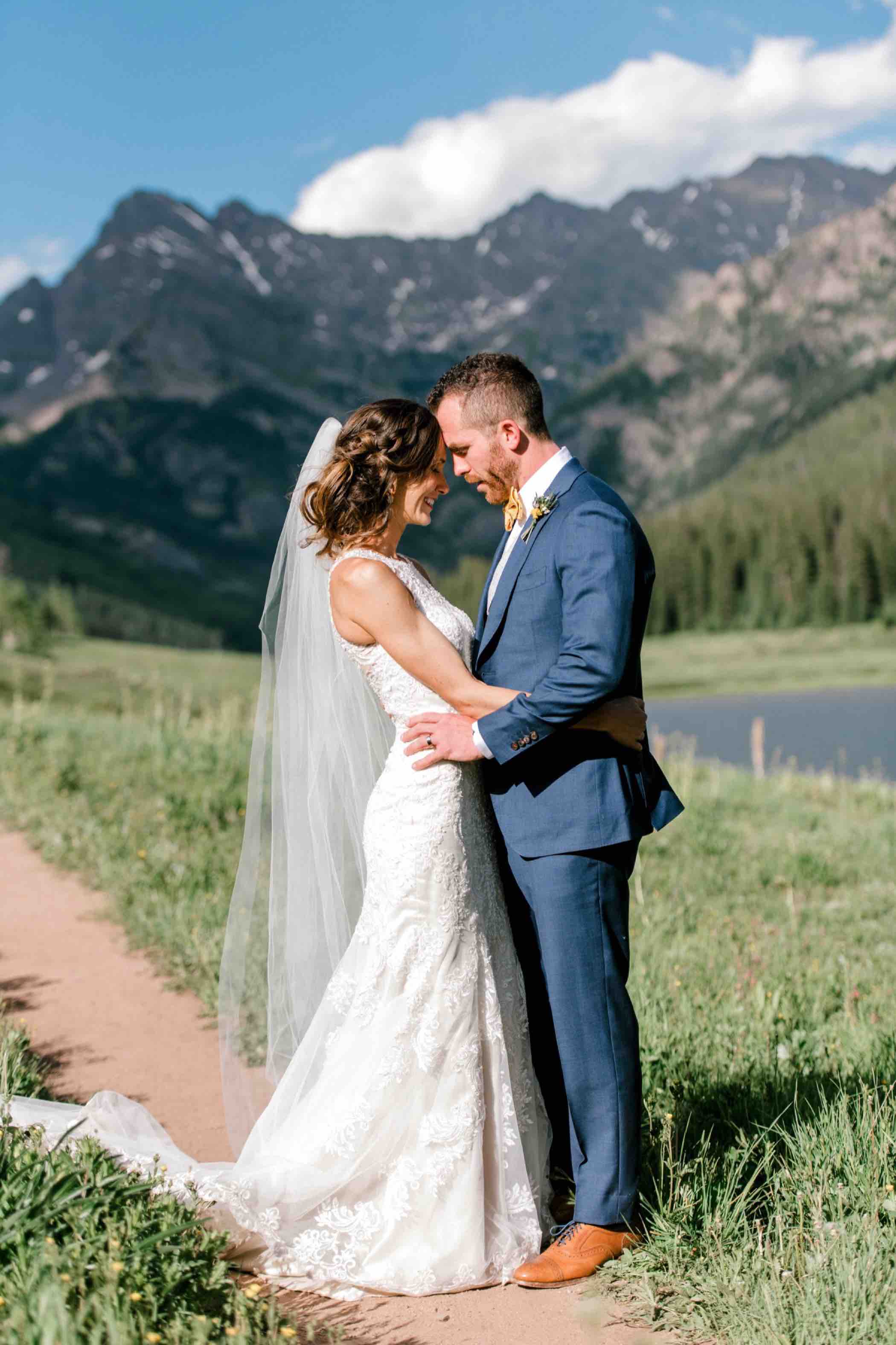 Bride and groom portraits at Piney River Ranch with the mountains of the Gore Range in Vail Colorado. Photo by Ali and Garrett, Romantic, Adventurous, Nostalgic Wedding Photographers.