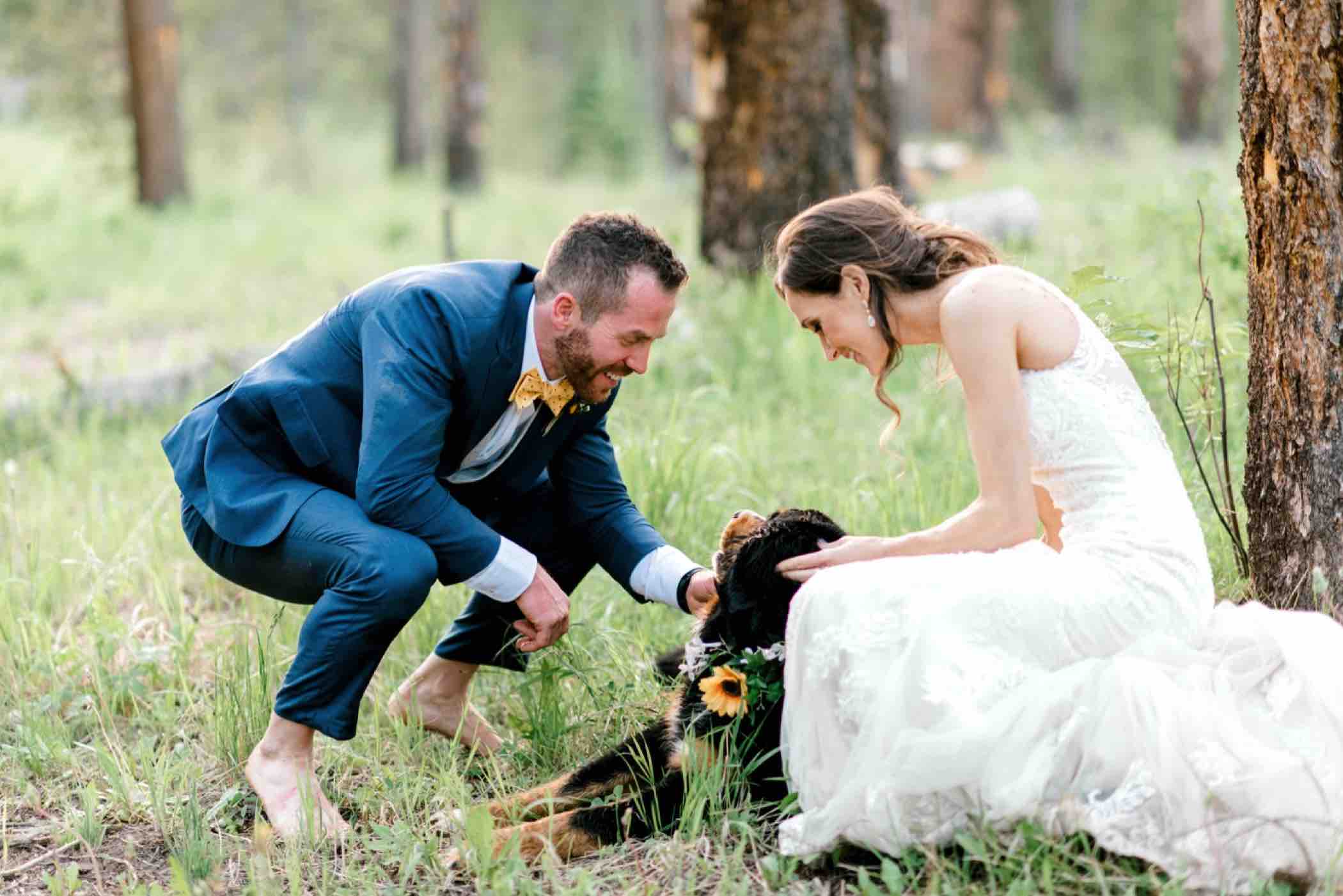 Kris and Sallie say hi to their flower dog, their Bernese Mountain Dog Lucie after their wedding ceremony at the Piney River Ranch in Vail, Colorado. Photo by Ali and Garrett, Romantic, Adventurous, Nostalgic Wedding Photographers.