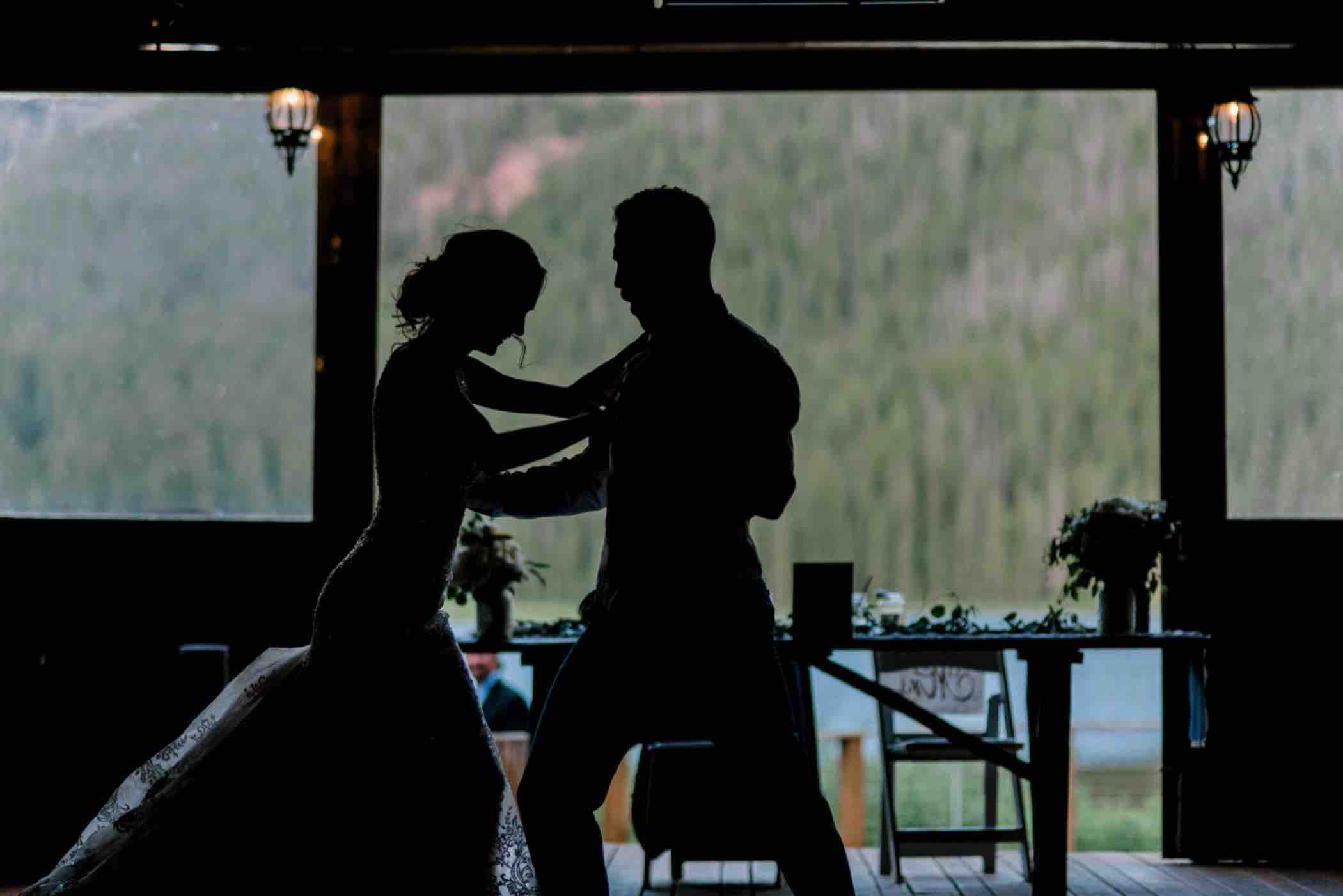 Silhouette of bride and groom during their first dance as a married couple in Piney River Ranch in Vail, Colorado.Photo by Ali and Garrett, Romantic, Adventurous, Nostalgic Wedding Photographers.