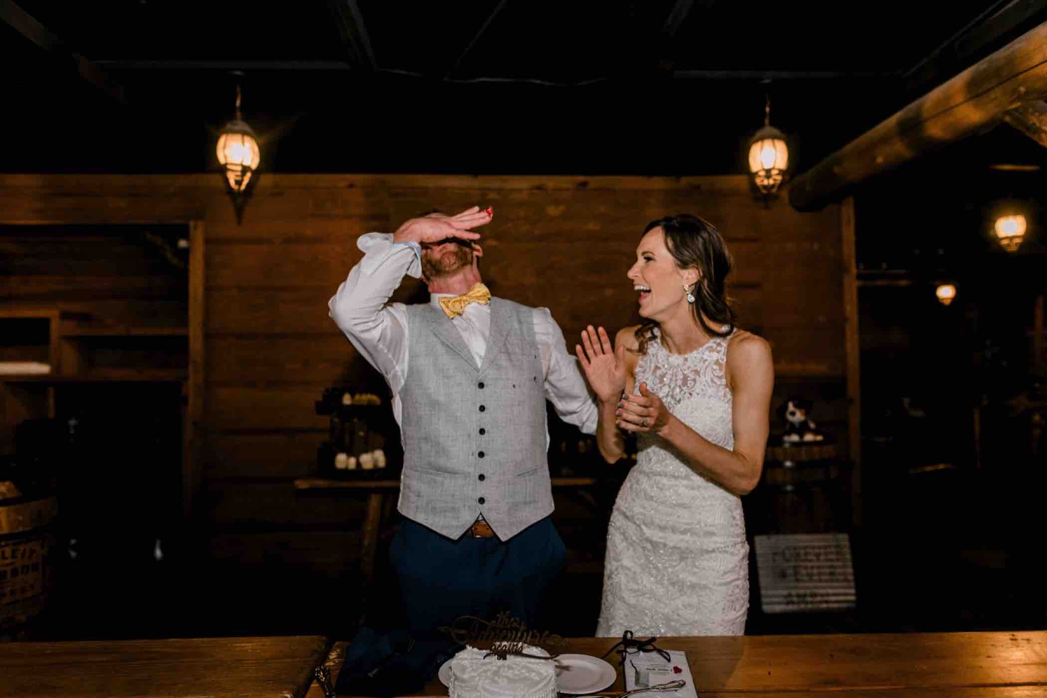 Kris and Sallie get ready to cut the cake at their wedding reception at Piney River Ranch in Vail, Colorado. Photo by Ali and Garrett, Romantic, Adventurous, Nostalgic Wedding Photographers.