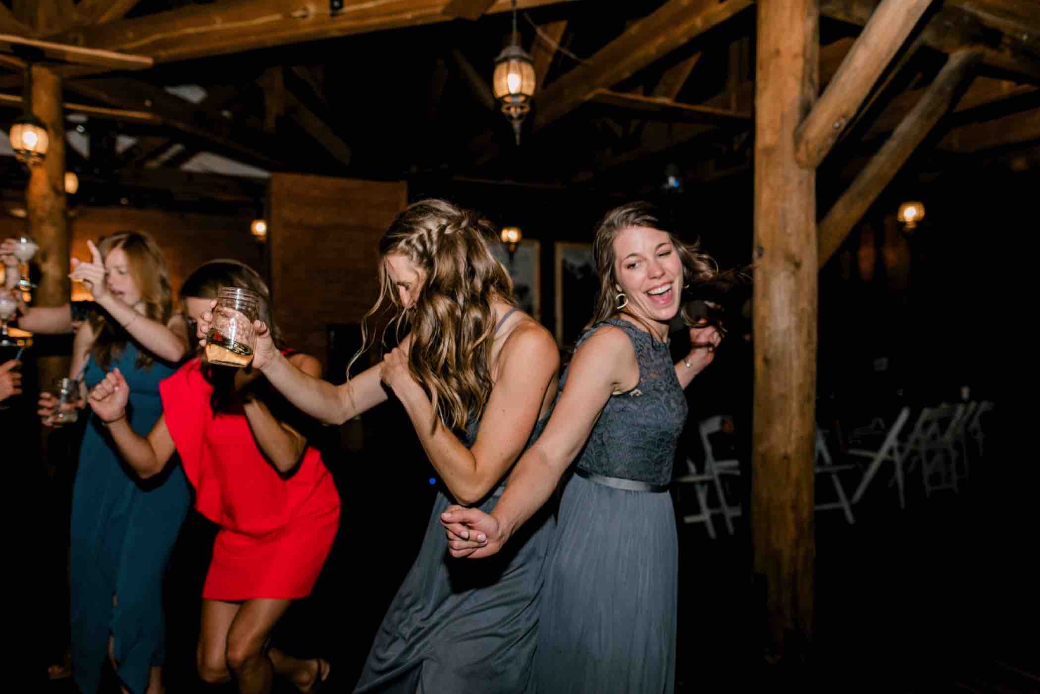 Guests dance during Kris and Sallie's wedding reception at Piney River Ranch in Vail, Colorado. Photo by Ali and Garrett, Romantic, Adventurous, Nostalgic Wedding Photographers.