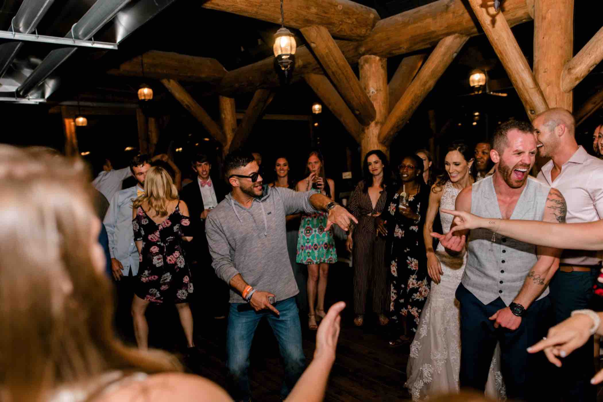 Guests dance at Kris and Sallie's wedding at Piney River Ranch in Vail, Colorado. Photo by Ali and Garrett, Romantic, Adventurous, Nostalgic Wedding Photographers.