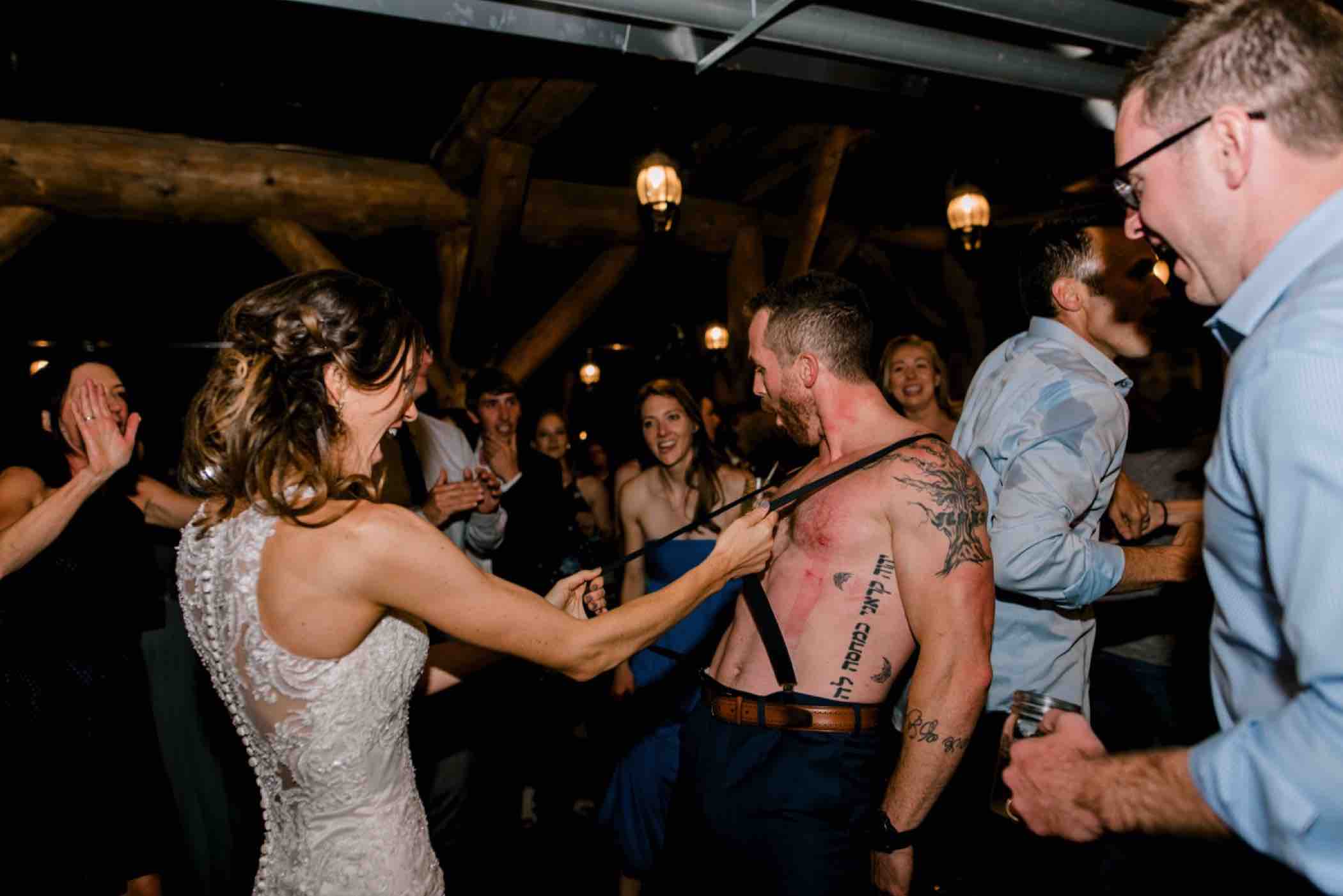 The groom surprised the bride by returning shirtless to his wedding reception at Piney River Ranch in Vail, Colorado. Photo by Ali and Garrett, Romantic, Adventurous, Nostalgic Wedding Photographers.