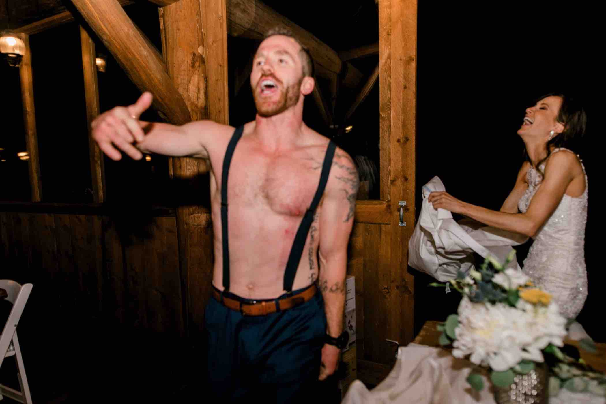 The groom dances shirtless at his wedding reception at Piney River Ranch in Vail, Colorado. Photo by Ali and Garrett, Romantic, Adventurous, Nostalgic Wedding Photographers.
