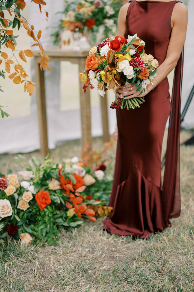 Bridesmaid Wearing Merlot Gown at Wedding Ceremony